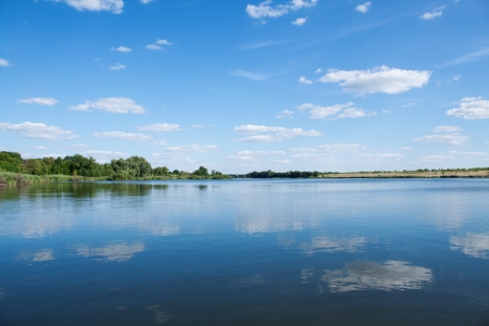 Lake under blue cloudy sky の写真素材