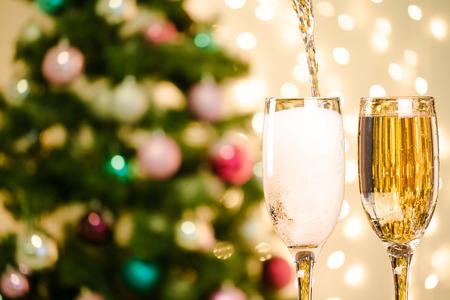 Two Champagne Glasses On Defocused Background Living Room With Christmas Treeの写真素材