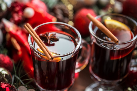 Christmas hot mulled wine with spices on a wooden table. The idea for creating greeting cardsの写真素材