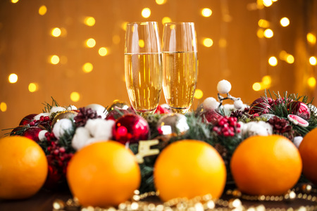 Two champagne glass on christmas bokeh backgroundの写真素材