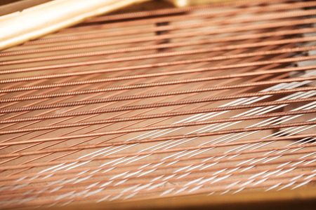 Close up image of interior of grand piano showing strings and structureの写真素材