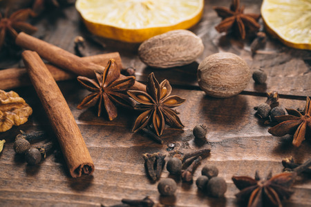 Collection of spices for mulled wine and pastry on the wooden table