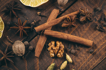Collection of spices for mulled wine and pastry on the wooden tableの写真素材