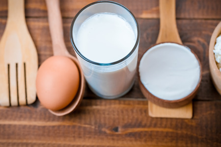 Natural homemade products: milk, cheese, sour cream and eggs on old wooden backgroundの写真素材