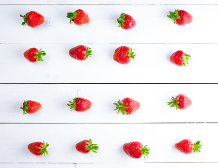 Beautiful background with fresh ripe strawberries on white wooden backgroundの写真素材