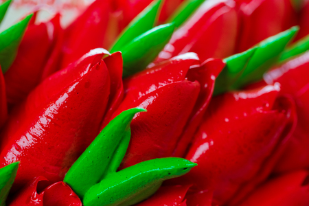 Background beautiful birthday cake adorned with edible red tulips