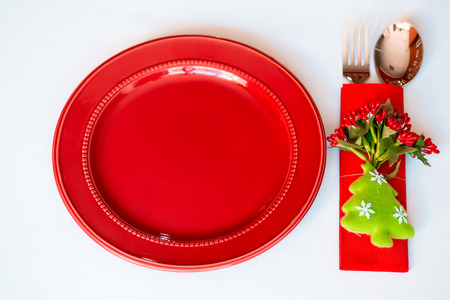 Christmas background - elegant red plate with cookies and spoon, fork, knife.の写真素材