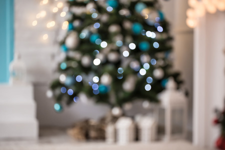 Beautiful Defocused background Living new year room with decorated Christmas tree, gifts and fireplace. The idea for postcards. Soft focus. Shallow DOFの写真素材