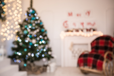 Beautiful Defocused background Living new year room with decorated Christmas tree, gifts and fireplace. The idea for postcards. Soft focus. Shallow DOFの写真素材