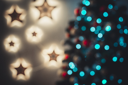 Closeup of Christmas-tree background in the living room of the house with glowing stars on the wallの写真素材