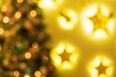 Closeup of Christmas-tree background in the living room of the house with glowing stars on the wall