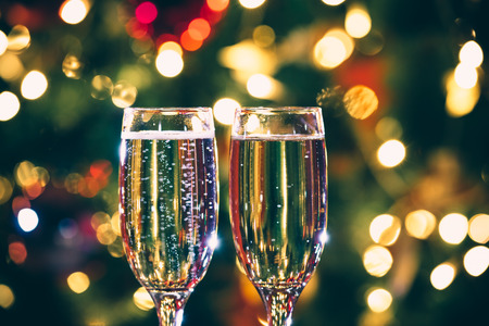 Beautiful two glasses of champagne standing on the table in the background of a blurred room with a...