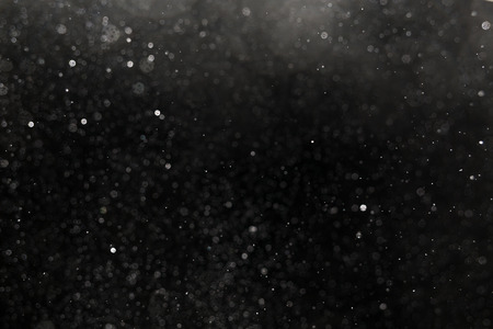 Falling snow on black backgroundの写真素材