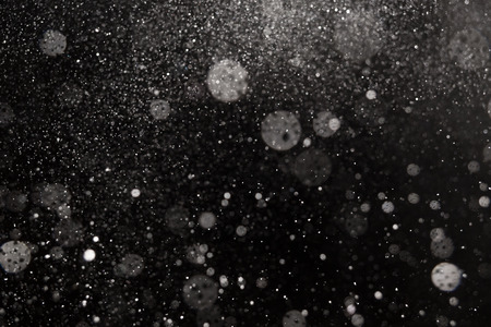 Falling snow on black background