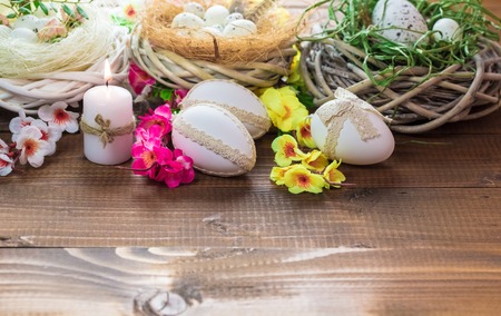 Beautiful Easter eggs with flowers on the wooden backgroundの写真素材