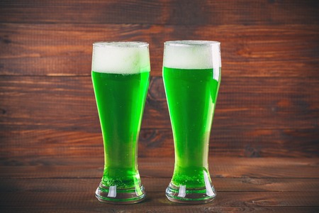 St Patrick's Day concept two mug green beer against wooden backgroundの写真素材