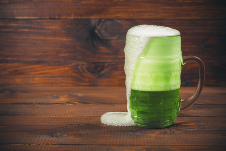 St Patrick's Day concept mug green beer against wooden backgroundの写真素材