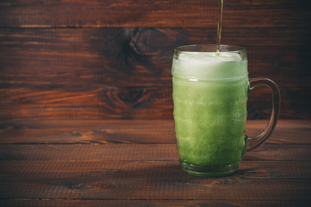 St Patrick's Day concept mug green beer against wooden backgroundの写真素材