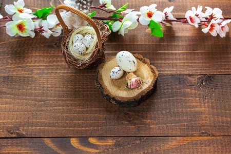 Beautiful Easter eggs with flowers on the wooden background