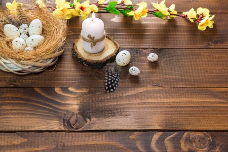 Beautiful Easter eggs with flowers on the wooden backgroundの写真素材
