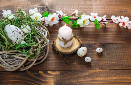 Beautiful Easter eggs with flowers on the wooden backgroundの写真素材