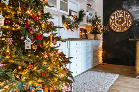 Christmas living room with a Christmas tree, gifts and clock. Beautiful New Year decorated classic home interior. Winter backgroundの写真素材