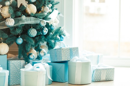Christmas living room with a Christmas tree, gifts and a large window. Beautiful New Year decorated classic home interiorの写真素材