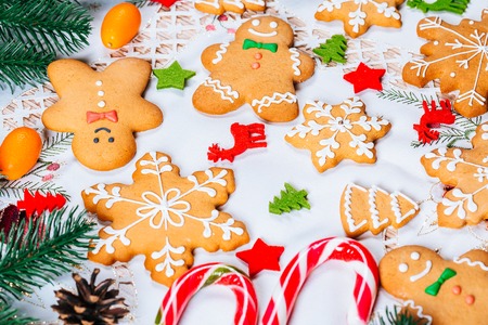 Christmas gingerbread cookies homemade with branches of Christmas tree and New Year decor on table...