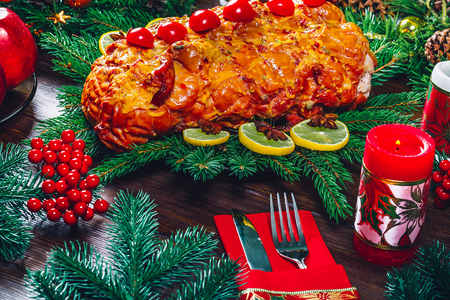 Christmas table dinner time with roasted meats, candles and New Year decor. Background thanksgiving.の写真素材