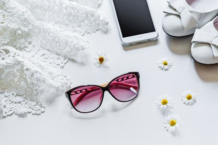 Travel concept summer background, sunglasses, flowers, mobile phone. Overhead view of Traveler's accessories. Essential vacation items, love story, go to see the world. Flat layの写真素材