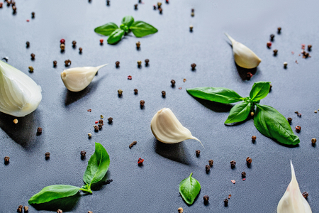 Top Down View On Kitchen Ingredients Like Garlic, Basil, Spices And Herbs On Slate Stone, With Free Spaceの写真素材