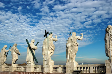 Statues of Saints of the Colonial of St. Peter back view in Rome against the background of cloudy...