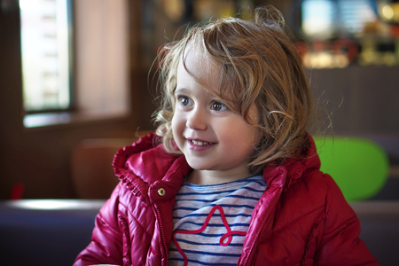 Portrait of Little baby girl smiling and looking sidewaysの写真素材