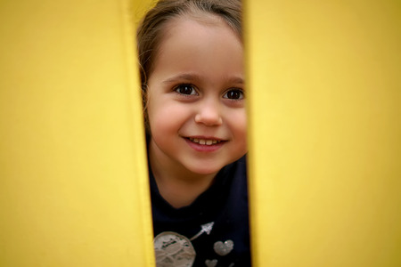 Little happy girl playing on the playgroundの写真素材