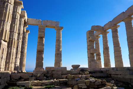 Temple of Poseidon at Cape Sounion, facing a stunning blue skyの写真素材