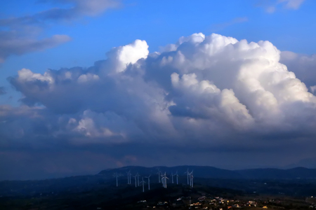 Dramatic sky before the rain over wind electric millsの写真素材