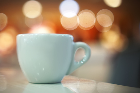 a cup of coffee on a bokeh background textの写真素材