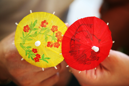 Paper decorative umbrellas in hands of coupleの写真素材