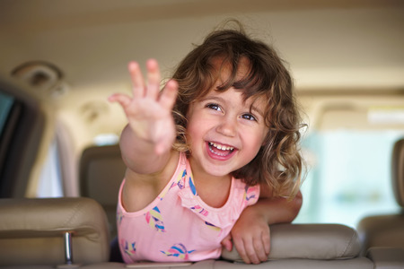 Little cute girl looks happy in the carの写真素材