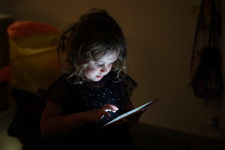 baby girl playing with mobile phoneの写真素材