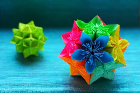 Two Kusudama origami on blue background closeupの写真素材