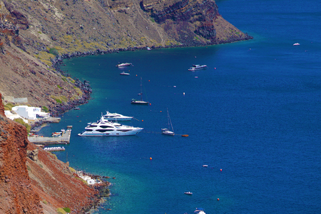 OIA, motorboats and sailing ship in the sea of Santorini, Greeceの写真素材