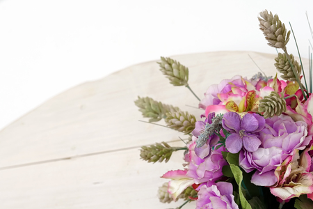 Composition of artificial flowers on a white background, copy spaceの写真素材