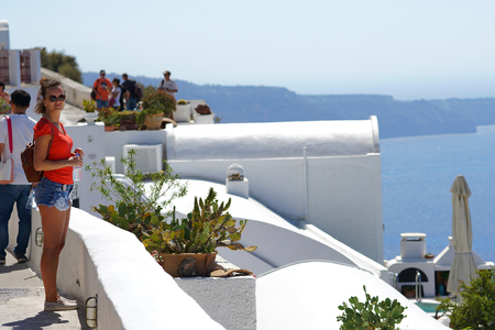 Santorini, Greece, September 21 2018, A beautiful tourist admires the Caldera landscapeのeditorial素材