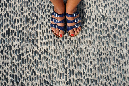 Detail of pattern with feet and sandals of womanの写真素材