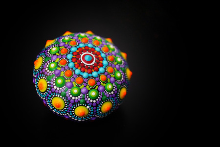 Beautiful mandala rock on black backgroundの写真素材