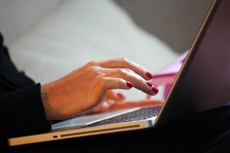 Woman hands working on laptop until late at night