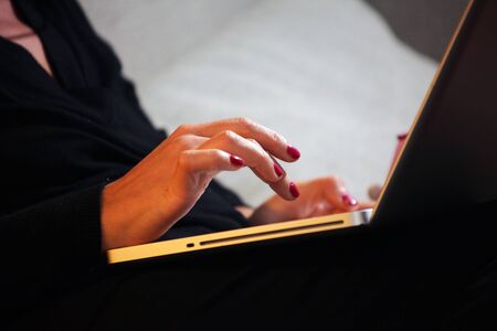 Woman hands working on laptop until late at nightの写真素材