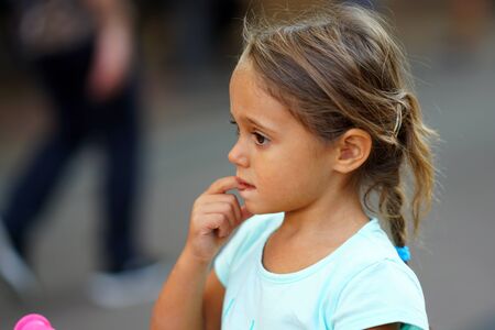 Portrait of 4 year old girl on the blurred background of a shopping street in Sofia, Bulgariaの写真素材