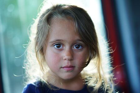 Portrait of a 4-year-old girl looking straight at the camera